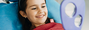 Child smiling during preventive dentistry visit