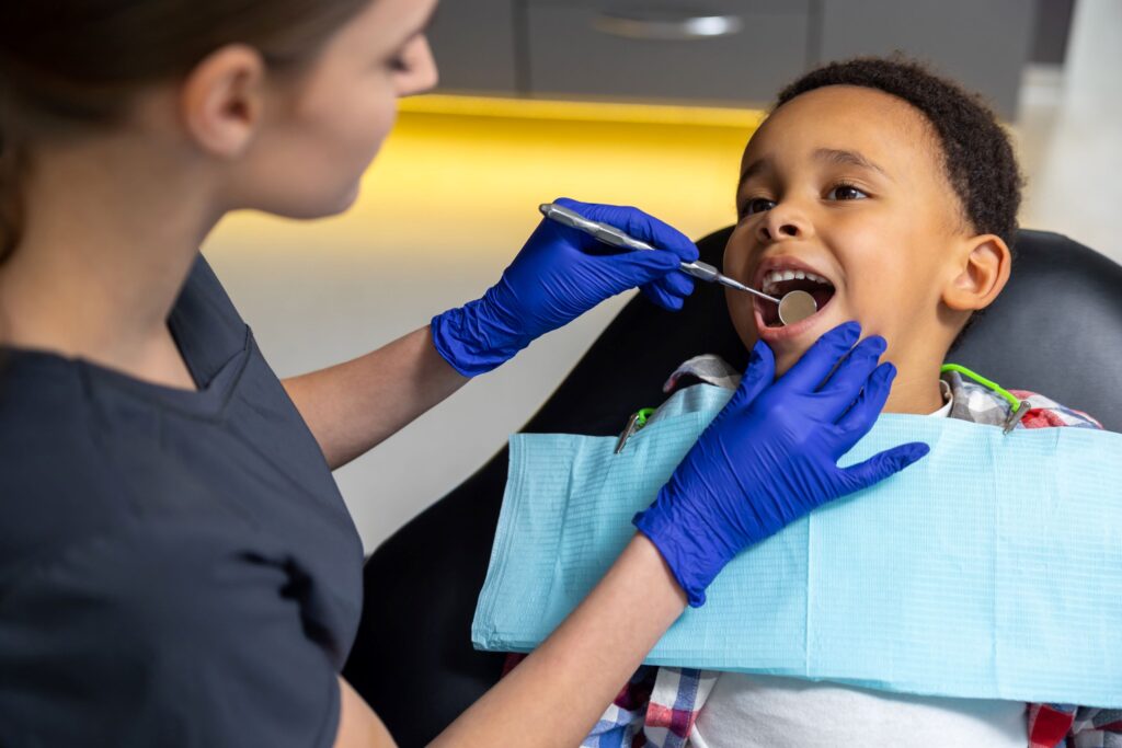 Boy in dental chair undergoing exam