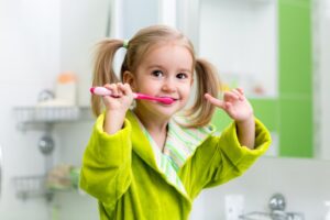 Kid brushing teeth.
